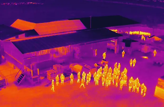 The thermal image of a group of people in the village